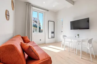 a living room with a couch and a table at RIVIERA COZY - Place Massena in Nice