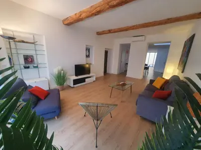 a living room with two blue couches and a table at Loft - 
