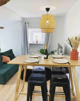 a dining room with a table and wine glasses at Beautiful refurbished cozy apartment in Nice