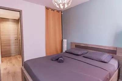 a bedroom with a bed and a chandelier at Beautiful 3 room apartment - Parking -Centre -Tram in Nice