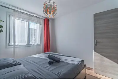 a bedroom with a bed and a window at Beautiful 3 room apartment - Parking -Centre -Tram in Nice