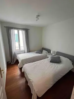 a bedroom with two beds and a window at Beautiful apartment - Centre in Cagnes-sur-Mer