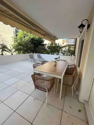 a wooden table and chairs on a patio at Beautiful apartment - Centre in Cagnes-sur-Mer