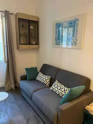 a living room with a couch and a table at Massena : Hyper Centre Studio 2p in Nice