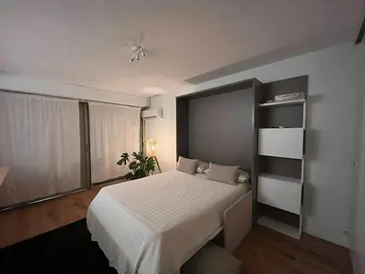 a bedroom with a bed and a book shelf at Beautiful studio - Terrace in Nice