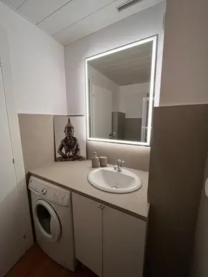 a bathroom with a sink and a washing machine at Beautiful studio - Terrace in Nice
