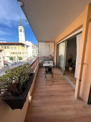a balcony with a table and chairs on a building at Beautiful studio - Terrace in Nice