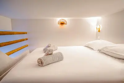 a white bedroom with two towels on a bed at The Calypso - Quiet - New - Central in Nice