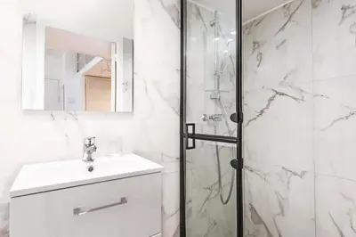 a white bathroom with a shower and a sink at The Calypso - Quiet - New - Central in Nice