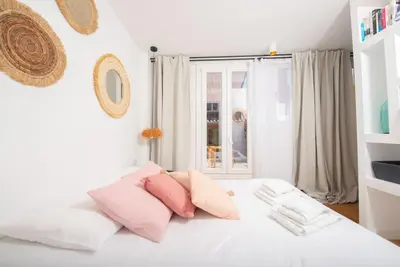 a white bed with pink pillows and a window at #30 Old Town, Castle panoramic View / Terrace & AC in Nice
