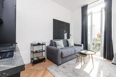 a living room with a couch and a table at 7 FOCH 202 - Studio contemporain en plein coeur de Nice - climatisation in Nice
