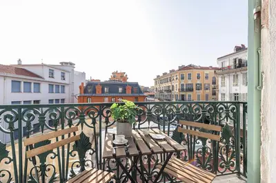 a balcony with two benches and a table with a plant at 7 FOCH 202 - Studio contemporain en plein coeur de Nice - climatisation in Nice