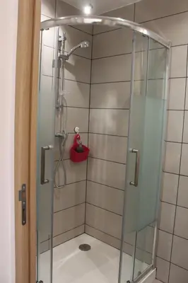 a shower with a glass door in a bathroom at Petite maison, cosy, sur les collines niçoises in Nice