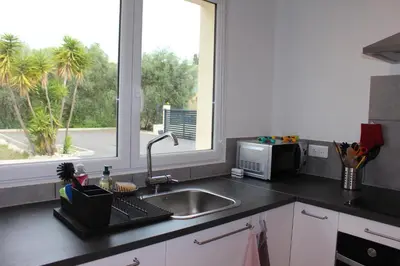 a kitchen counter with a sink and a window at Petite maison, cosy, sur les collines niçoises in Nice