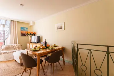 a room with a table and chairs and a bedroom at LA CASA AP4409 By Riviera Holiday Homes in Villefranche-sur-Mer