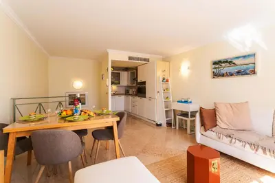 a living room with a table and a couch at LA CASA AP4409 By Riviera Holiday Homes in Villefranche-sur-Mer