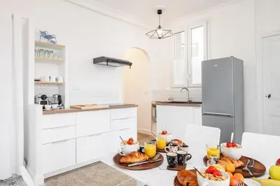 a kitchen with a table with breakfast foods and orange juice at MY CASA - MEDECIN 43 - Superb Bright City Center Apartment in Nice