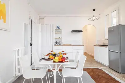 a white kitchen with a white table and white chairs at MY CASA - MEDECIN 43 - Superb Bright City Center Apartment in Nice