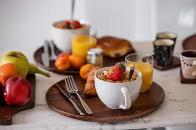 a breakfast table with a bowl of cereal and fruit at MY CASA - MEDECIN 43 - Superb Bright City Center Apartment in Nice