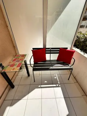 two red pillows sitting on a bench in a building at Suite DES DOMES FSHH in Nice