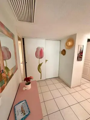 a room with a table and a flower on the wall at Suite DES DOMES FSHH in Nice