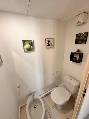 a white bathroom with a toilet and a sink at Suite DES DOMES FSHH in Nice