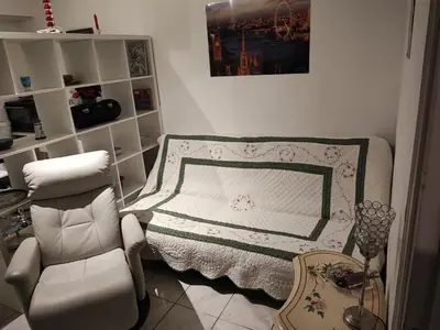 a bedroom with a bed and a chair and a table at Beau studio meublé hyper centre Nice in Nice