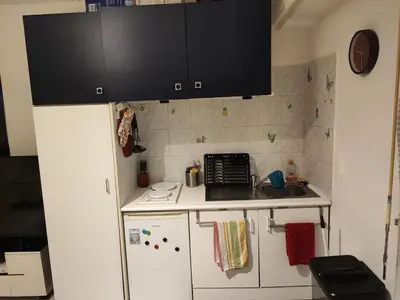 a small kitchen with a sink and a refrigerator at Beau studio meublé hyper centre Nice in Nice