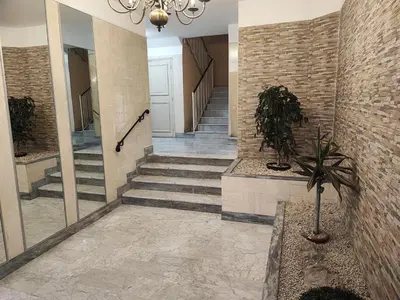 a lobby with stairs and a chandelier at Beau studio meublé hyper centre Nice in Nice