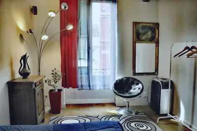 a living room with a chair and a window at Nice - Stylish apartment downtown in Nice