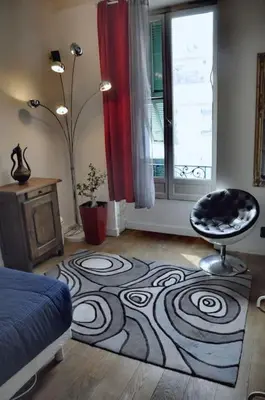 a bedroom with a bed and a rug on the floor at Nice - Stylish apartment downtown in Nice