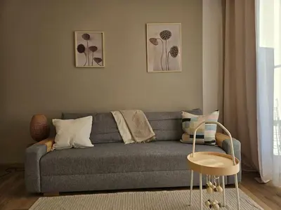 a living room with a gray couch and a table at Le plein ciel Studio in Nice