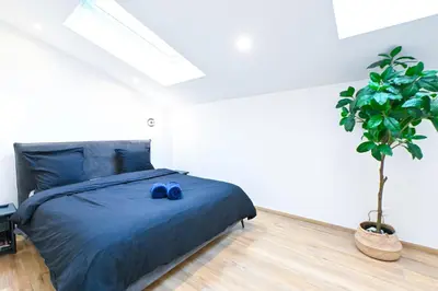 a bedroom with a blue bed with blue shoes on it at Beau deux pièces cozy avec terrasse n11 in Nice