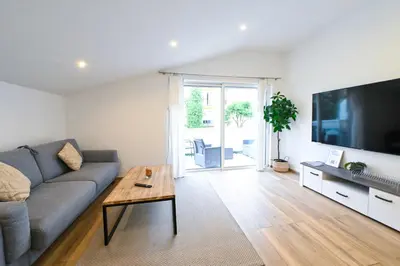 a living room with a couch and a large flat screen tv at Beau deux pièces cozy avec terrasse n11 in Nice