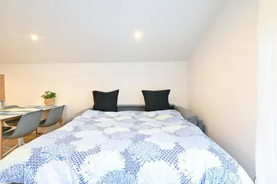 a bedroom with a bed and a table and chairs at Beau deux pièces cozy avec terrasse n11 in Nice