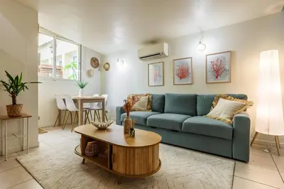 a living room with a blue couch and a table at 3 pièces au cœur du carré d'or in Nice