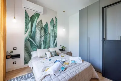 a bedroom with a large bed with a mural on the wall at MY CASA - GUIDONI - Superb City Center Suite Apartment in Nice