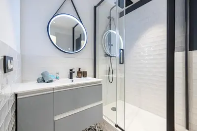 a bathroom with a shower and a sink and a mirror at MY CASA - GUIDONI - Superb City Center Suite Apartment in Nice