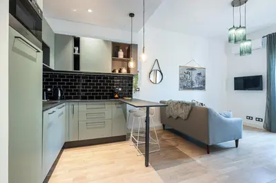 a kitchen with a table and a couch in a room at MY CASA - GUIDONI - Superb City Center Suite Apartment in Nice