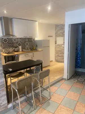a kitchen with a table and chairs in a room at Appartement Nice proche de Monaco in Nice