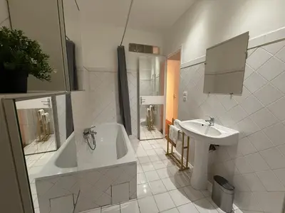 a white bathroom with a tub and a sink at Sublime appartement 4P classé dans le Vieux-Nice in Nice