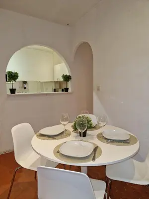 a white dining room with a white table and chairs at Sublime appartement 4P classé dans le Vieux-Nice in Nice