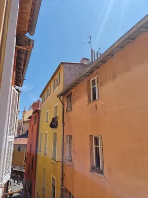 a view of an alley between two buildings at Sublime appartement 4P classé dans le Vieux-Nice in Nice
