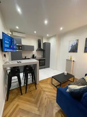 a kitchen and living room with a blue couch at Appart Cosy, Proche Gare in Nice