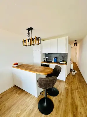 a kitchen with white cabinets and a wooden counter top at Cote d’Azur Charm, Studio Apartment with panoramic seaview in Nice in Nice