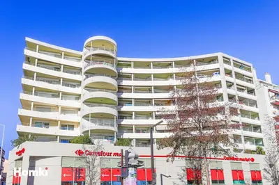 a tall white building with a christmas tree in front of it at Cote d’Azur Charm, Studio Apartment with panoramic seaview in Nice in Nice