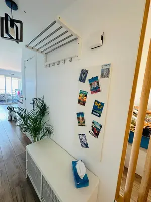 a room with a white wall with pictures on it at Cote d’Azur Charm, Studio Apartment with panoramic seaview in Nice in Nice