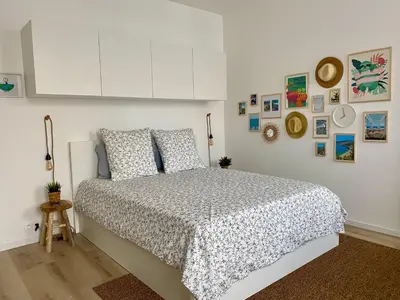 a bedroom with a bed and some pictures on the wall at Royal Studio Massena in Nice