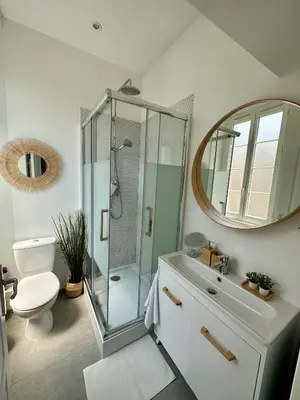 a bathroom with a shower and a toilet and a mirror at Royal Studio Massena in Nice