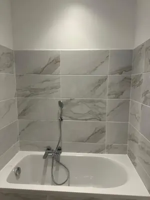 a white bath tub with a hose in a bathroom at STUDIO REFAIT A NEUF CENTRE DE NICE in Nice